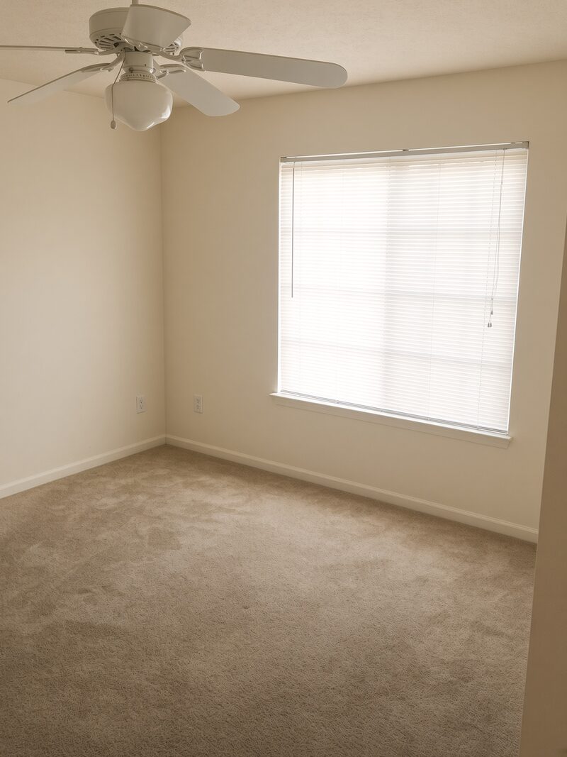 Bedroom with a window and blinds, walls and ceiling finished.