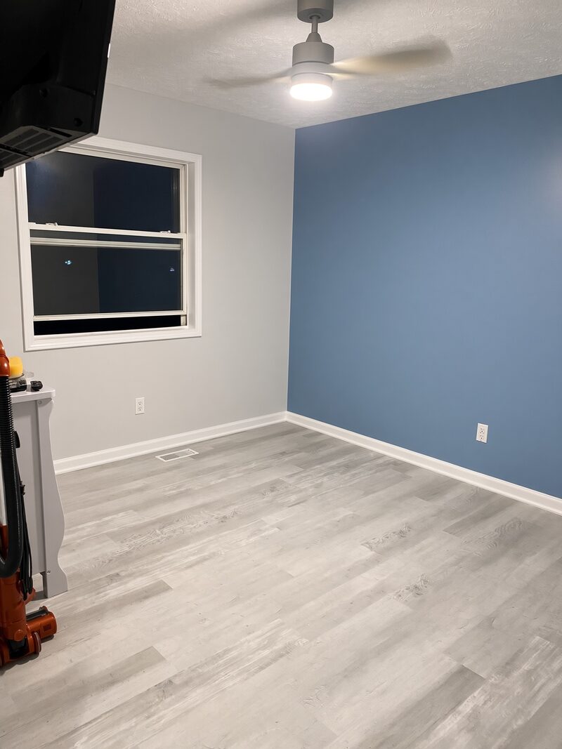 Blue walls carried around a window with white trim.