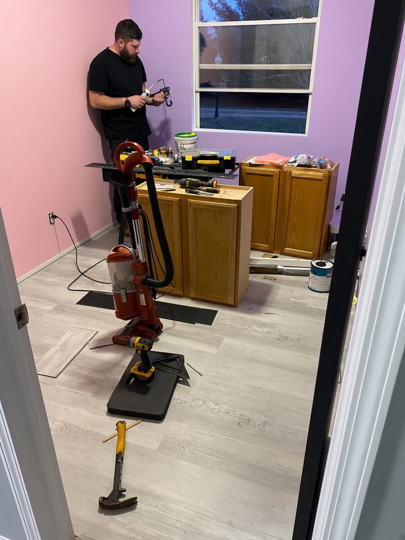 Kitchen going in around oak cabinets with mauve and purple walls.