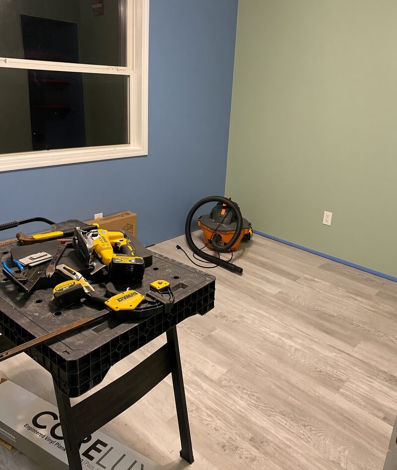 Blue and green walls meeting at a corner with the tools still set up.