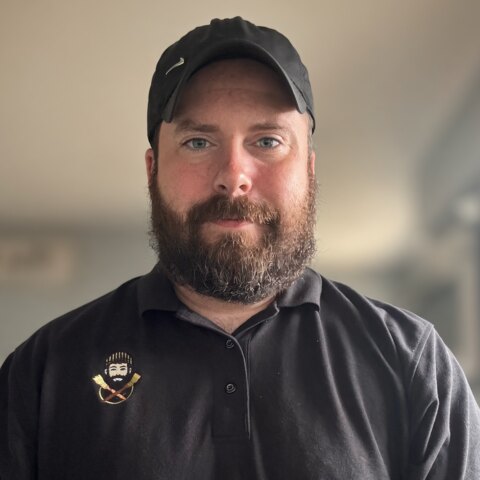 Stephen Jerge, owner of Traveling Man Painting Co., in a branded polo and cap.